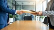 © alex - Professional colleagues exchanging important documents across a conference table in a modern office, signifying a crucial business transaction or handover