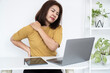 © doucefleur - Asian female worker suffering from severe back and shoulder pain while working on a laptop at her office desk. Concept of office syndrome, muscle strain, ergonomic injury, and stress