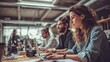 © Maham - A group of young professionals working together in a modern office space with laptops and cameras