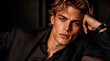 © Tom - Close-up studio portrait of a handsome young man with blonde hair, wearing a luxury black suit and elegant watch. The professional editorial lighting emphasizes his sharp facial features, creating a h