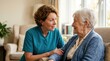 © Sofia - Caregiver talking to an elderly woman with a hearing aid. Professional home care support for senior citizens