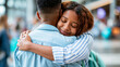 © Nataliya - Two anonymous people sharing a warm embrace at an airport terminal, heartfelt greeting or farewell concept, faceless, defocused busy background, with copy space