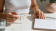 © Victoria - woman checking pregnancy test result with calendar. Girl tracking fertility cycle and planning maternity. Medical healthcare diagnostic, family planning and motherhood preparation concept