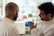 © BusinessClass by W61 - Scientists discussing brain research data on smartphone in laboratory