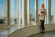 © BusinessClass by W61 - Smiling businesswoman relaxing by the window in a sunny office