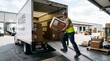 © M.Husni - Efficient logistics worker loading cardboard boxes onto a delivery truck at a busy warehouse dock, highlighting reliable package distribution and essential supply chain operations