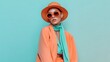 © Hot - Stylish young woman in vibrant coral and turquoise outfit against clean pastel background, bold contemporary summer fashion, editorial photography