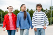 © Maria Vitkovska - Diverse teenagers walking happily embracing youth culture