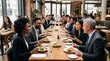 © Felippe Lopes - Diverse group of professionals enjoying a business lunch at a modern restaurant with elegant table setting and delicious food