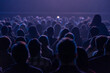 © Anton Gvozdikov - Large seated audience watching stage performance in darkened venue, blue lighting creates moody atmosphere.