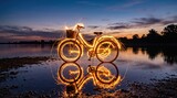 Reflection of glowing bicycle wheels in calm lake at golden sunset with warm light