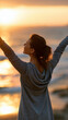 © Laura - Happy woman with arms raised wide open enjoying freedom at the beach at sunset, wellness success and travel concept, positive outdoor lifestyle, faceless, back view, defocused