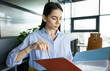 © be free - Business professional woman reading paper financial report. Reviewing contract. Woman reviewing document in office. Businesswoman checking data. Business success. Successful businesswoman assistant