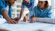 © Nataliya - Faceless team of architects and designers collaborating over large printed blueprints spread across a meeting table, a modern construction site visible through the window,