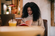 © BullRun - Talented Black writer writing notebook research project planning checklist. Creative African American student studying online freelance remote office workspace, real people equity inclusion