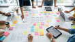 © Hifzhan Graphics - Team of designers collaborating on mobile app interface wireframes