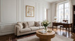 © Chari - A bright, elegant living room with a sofa, coffee table, and a wooden desk by the window. Natural light fills the space, creating a serene atmosphere.
