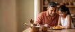 © Fernando - Indian father and daughter cooking healthy fruit salad in rustic kitchen together; happy family bonding over fresh food preparation in warm home dining atmosphere, copy space for healthy lifestyle.