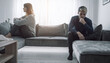 © SolaruS - This poignant stock image of an unhappy couple sitting apart on a sofa beautifully conveys concepts of relationship breakdown, divorce, silent conflict, and emotional distance.