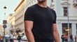 © ENDRA - Confident man in casual black t-shirt walking through urban city street