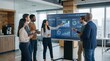 © Lexxdev - A diverse team of business professionals collaborating and analyzing data on a large interactive screen in a modern office environment.