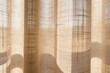 © K - Soft natural light filtering through textured curtains