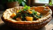 © Vadym - Ethiopian yeabesha gomen stew with cabbage and potatoes served in injera bread bowl. Richly spiced collard greens dish presented in rustic woven basket. Traditional African food from East Africa.