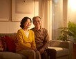 © Berkah9 - Smiling older couple sitting on a sofa in a warmly lit living room