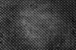 ©  SobuzForge - Close-up metallic diamond plate texture with weathered surface in dramatic dark lighting for industrial backgrounds