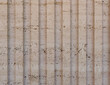 © IULIIA - Unfilled travertine stone texture with vertical fluted grooves and natural limestone character suitable for elegant interior walls and architectural surface design