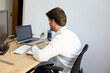 © ADDICTIVE STOCK - Professional working at desk with laptop and monitor