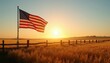 © Viktor - American flag waves over golden wheat field near wooden fence at sunrise. Rural landscape shows agriculture, patriotism, and freedom under a clear sky. Serene morning.