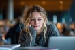 © Novanture - focused student studying on laptop