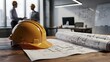 © Behrozcreations - Construction hard hat and architectural blueprints on a wooden office desk with engineers discussing in the background
