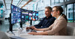 © Andrey Popov - Financial Analyst And Colleague Monitor Business Data Dashboard