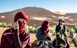 © Cavan Images - portrait of woman wearing a turban in the Sahara desert