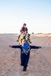 © Cavan Images - woman enjoying a camel ride in the Sahara