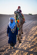© Cavan Images - woman enjoying a camel ride in the Sahara