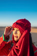 © Cavan Images - portrait of woman wearing a turban in the Sahara desert
