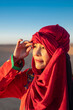 © Cavan Images - portrait of woman wearing a turban in the Sahara desert