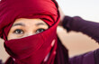 © Cavan Images - portrait of woman wearing a turban in the Sahara desert