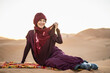 © Cavan Images - portrait of woman wearing a turban in the Sahara desert
