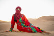 © Cavan Images - portrait of woman wearing a turban in the Sahara desert