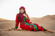 © Cavan Images - portrait of woman wearing a turban in the Sahara desert