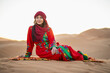 © Cavan Images - portrait of woman wearing a turban in the Sahara desert