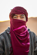 © Cavan Images - portrait of man wearing a turban in the Sahara desert