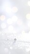 © Dery - Delicate white ornament on a sparkling surface with bokeh lights.