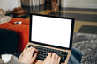 © KEA - laptop mockup  Person typing on a laptop with a blank white screen, suggesting remote work, online communication, writing and productivity in a casual home workspace or freelance