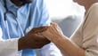 © ruangrit19 - A professional doctor holding the hands of an elderly patient providing comfort and empathetic support during a medical consultation session.