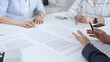 © volha_r - Business partners discussing legal contracts and partnership agreements, reviewing terms, collaborating on documents during an important professional meeting in an office setting